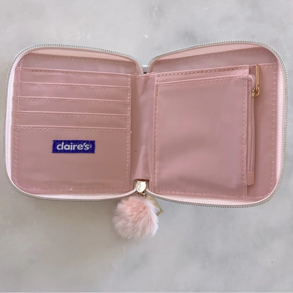 Claire’s pink tie dye wallet with pom pom zipper.